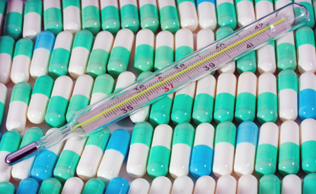 Painkiller tablet Medical background multi-colored pills concept pharmacy, thermometer for measuring...