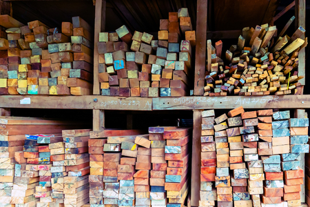 Colorful colored butt ends stacked logs long board wooden planks texture wood background wood board hardwoodの写真素材