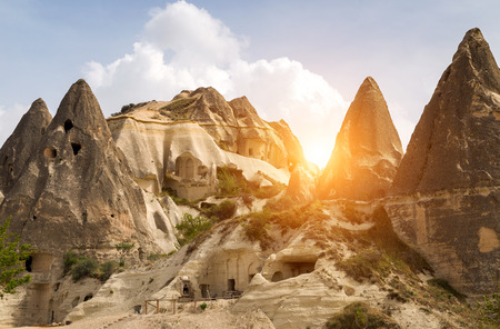 Valley and village with its fairy chimneys, rock formations and cave houses, Stone formations in Cappadocia, Turkey.の写真素材