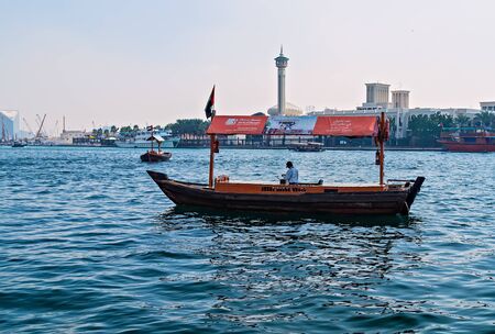 DUBAI, UAE - 23 JANUARY, 2016: Motorized Water Taxi boat Abra ferries on the Bay Creek wooden vessel in Dubai sea view old town.のeditorial素材