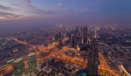 DUBAI, UAE - January 23, 2016: Downtown Dubai city lights sheik Zayed skyline at night with roads, shot from the tower Burj Khalifaのeditorial素材