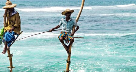 KOGGALA, Sri Lanka - February 09, 2016: Local traditional stilt fishermen rod in Indian ocean, Sri Lanka.のeditorial素材