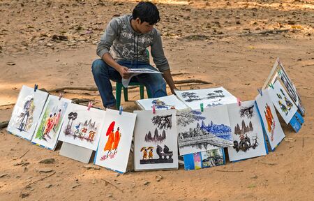 SIEM REAP, CAMBODIA - March 01, 2015: Street artist sell paintings drawings of the picture Angkor Wat is a popular tourist attractionのeditorial素材