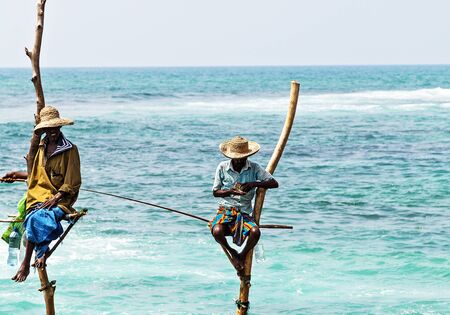 KOGGALA, Sri Lanka - February 09, 2016: Local traditional stilt fishermen in Sri Lanka.のeditorial素材