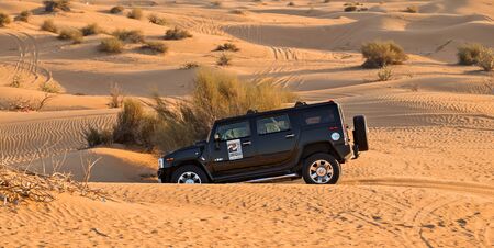 DUBAI, UNITED ARAB EMIRATES - JANUARY 25, 2016: Safari Hummer vehicle drives rally off-road car 4x4 adventure sand desert landscape, UAE, Dubai.のeditorial素材