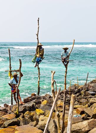 KOGGALA, Sri Lanka - February 09, 2016: Local traditional stilt fisherment ceylon, beach of Koggala type of fishing is traditional for Sri Lankaのeditorial素材