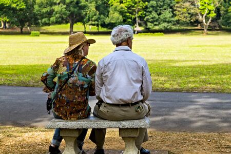SRI LANKA - FEBRUARY 07, 2016: Senior Couple, grandfather and grandmother relax sit on bench in Royal Botanical Gardens Kandy, Sri Lanka.のeditorial素材
