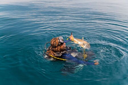 SRI LANKA, UNAVATUNA - 16 FEBR 2016: Sri Lankan Underwater shot of the hunter with spear gun with...