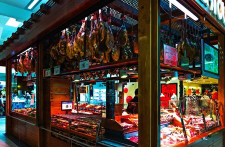 BARCELONA, SPAIN - August 1, 2012: Spanish hamon serrano prosciutto Boqueria Market in Las Ramblas Street. A bacon jamon iberico in view black leg pork famous food market in Barcelona.のeditorial素材