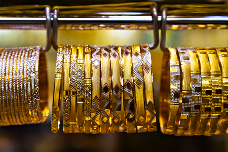 Gold jewelry bracelet display. jewellery ornaments shop display in gold market famous Golden souk in...