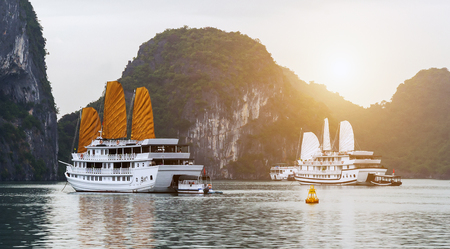 Discover Halong Bay Top Destinations Ha Long Bay is a    popular travel destination. Tourist boat high cliffs and lagoon sea waters of Ha Long Bay.の写真素材