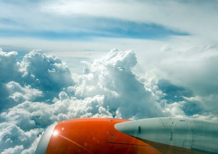 jet turbine airplane flying above white clouds in atmosphere paradise. Travel fly cruise transportation concept view from airplane porthole window on the turbine.の写真素材
