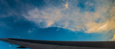 jet airplane flying above clouds in dramatic sunset. Travel fly cruise transportation concept view...