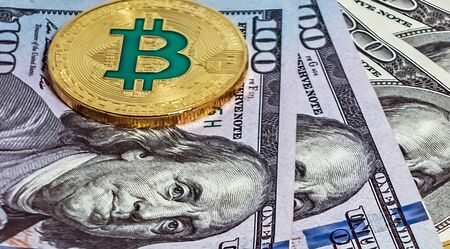Gold bitcoin coin Macro portrait of Benjamin Franklin one hundred dollars bills U.S. money american. background cryptocurrency mining concept.の写真素材