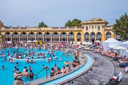 BUDAPEST, HUNGARY - August 24, 2019: Szechenyi Baths and and people public pools outdoor, Budapest. Largest thermal bath complex in Hungary and in Europe as well.のeditorial素材