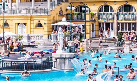 BUDAPEST, HUNGARY - August 24, 2019: Szechenyi Spa. Budapest world-famous thermal spring spa outdoor people public pools, Szechenyi Bath, Hungary.のeditorial素材