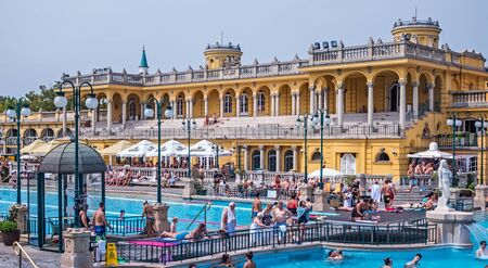 BUDAPEST, HUNGARY - August 24, 2019: Baroque-style domes mineral springs Szechenyi Spa people...