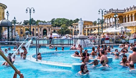 Szechenyi Spa Baths, Budapest. The palace-like edifice contains a huge thermal pool where people outdoor. BUDAPEST, HUNGARY. August 24, 2019.のeditorial素材