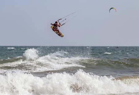 Mui Ne, Phan Thiet, Vietnam - Feb 16, 2015: Kitesurfer rides the waves sea water splash, attractive sport sea Mui Ne Coco Beach Phan Thiet Cam Ranh Bay Vietnam.のeditorial素材