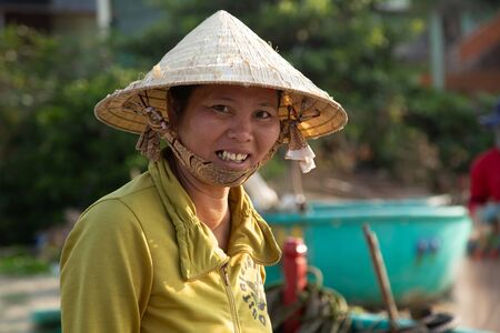 PHAN THIET, VIETNAM - Feb 16, 2015: Vietnamese Girl vietnam hat Slow life. People tropical beach with coconut palm trees, Phan Thiet. Travel Southeast Asia Coast Binh Thuan of Vietnam.のeditorial素材