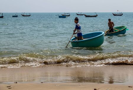 PHAN THIET, MUI NE, VIETNAM - Feb 16, 2015: Fisherman catch boats Vietnamese. People working at fishing pier in fishing village Phan Thiet, Travel Southeast Asia Coast Binh Thuan of Vietnam.のeditorial素材
