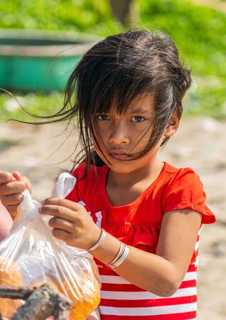 PHAN THIET, VIETNAM - Feb 16, 2015: Vietnamese Girl vietnam hat Slow life. People tropical beach with coconut palm trees, Phan Thiet. Travel Southeast Asia Coast Binh Thuan of Vietnam.のeditorial素材