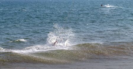 Mui Ne, Phan Thiet, Vietnam - Feb 16, 2015: Kitesurfer rides the waves sea water splash, attractive sport sea Mui Ne Coco Beach Phan Thiet Cam Ranh Bay Vietnam.のeditorial素材
