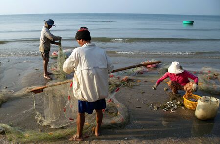 PHAN THIET, VIETNAM - Feb 16, 2015: People fisherman catch working at Vietnamese PHAN THIET harbour fishing village Vietnam. Travel Southeast Asia Coast Binh Thuan of Vietnam.のeditorial素材
