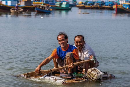 PHAN THIET, MUI NE, VIETNAM - Feb 16, 2015: Fisherman catch boats Vietnamese. People working at fishing pier in fishing village Phan Thiet, Travel Southeast Asia Coast Binh Thuan of Vietnam.のeditorial素材
