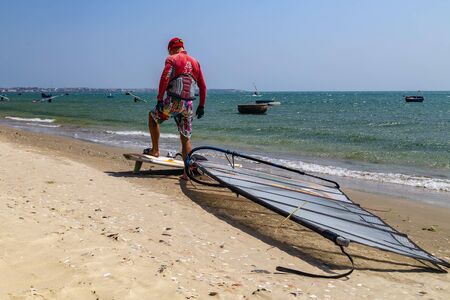 Mui Ne, Phan Thiet, Vietnam - Feb 16, 2015: Portrait of Kitesurfer inflate his kite.
