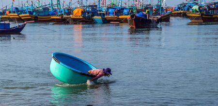 PHAN THIET, MUI NE, VIETNAM - Feb 16, 2015: Fisherman catch boats Vietnamese. People working at fishing pier in fishing village Phan Thiet, Travel Southeast Asia Coast Binh Thuan of Vietnam.のeditorial素材