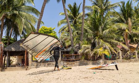 Mui Ne, Phan Thiet, Vietnam - Feb 16, 2015: Trainer education school surf in Mui Ne Coco Beach sand, palm trees. Tourists vacation Cam Ranh Bay in Vietnam. Windsurfing surface water sport.のeditorial素材