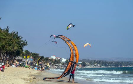 Mui Ne, Phan Thiet, Vietnam - Feb 16, 2015: Kitesurfer rides the waves sea water splash, attractive sport sea Mui Ne Coco Beach Phan Thiet Cam Ranh Bay Vietnam.のeditorial素材