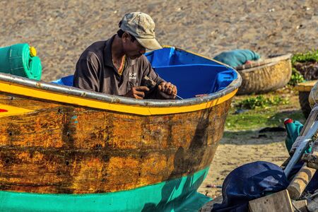 PHAN THIET, MUI NE, VIETNAM - Feb 16, 2015: Fishing Vietnamese boats at the sand beach Mui Ne in fishing village Phan Thiet, Travel Southeast Asia Coast Binh Thuan of Vietnam.のeditorial素材