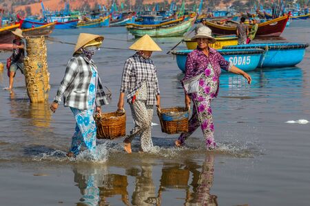 PHAN THIET, VIETNAM - Feb 16, 2015: People fisherman catch working at Vietnamese PHAN THIET harbour fishing village Vietnam. Travel Southeast Asia Coast Binh Thuan of Vietnam.のeditorial素材