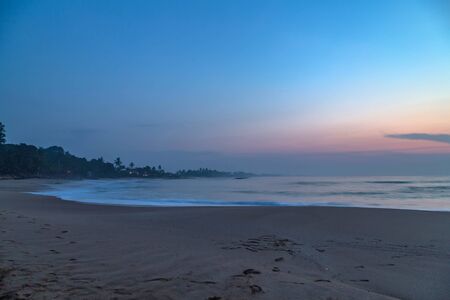 Low tide at sunset sunrise in the sea nature background ocean waveの写真素材