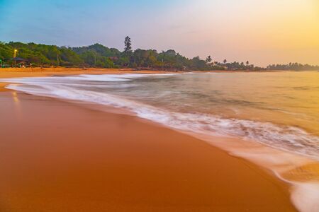 Low tide at sunset sunrise in the sea nature background ocean waveの写真素材