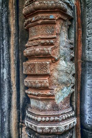 Khmer architecture Detailed carvings on the pink limestone walls of Banteay Srei temple near Angkor wat Siem Reap Cambodia. Bas-reliefs are individual figures jungles of ruins Angkor.の写真素材
