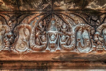 Banteay Srei Srey sanctuary temple Citadel of Women of beauty intricacy of the bas relief carvings walls buildings. Many niches in the temple walls contain carvings of devatas or dvarapalas. Cambodiaの写真素材