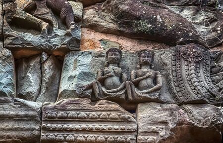 Khmer architecture Detailed carvings on the pink limestone walls of Banteay Srei temple Bas-reliefs are individual figures jungles of ruins Angkor near Angkor wat Siem Reap Cambodiaの写真素材