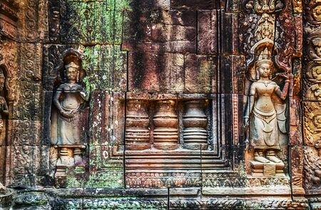 Old Carvings stone Apsara sculpture wal ruins temple Angkor Watの写真素材
