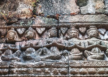 detail of ancient stone bas-relief carvings on the wall background texture - complex Angkor wat Cambodia.の写真素材