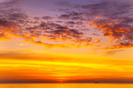 Sunset Gold sea background. Sunset sea waves morning sky. Summer sunset.の写真素材