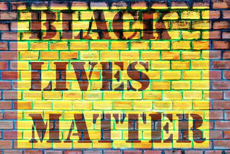 Black Lives Matter slogan text liberation banner designs stencil yellow stencil brick wall backgroundの写真素材
