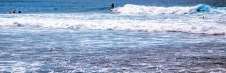 surfing in the ocean, male surfer cruising along a huge wave. Riding a Wave.の写真素材