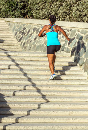 woman runner running climbing up stairs city street