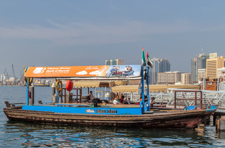 Dubai, UAE - JAN 23, 2016: Boats Abra ferries cruise business on the Bay Creek canal. RTA Abra water taxi station in Deira, United Arab Emiratesのeditorial素材
