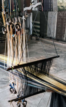 Traditional Detail of weaving loom for homemade silk. Handloom old Machine
