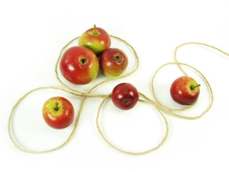composite: red apples and string on white backgroundの写真素材