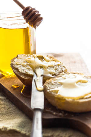 Roll and sweet honey on wooden backgroundの写真素材